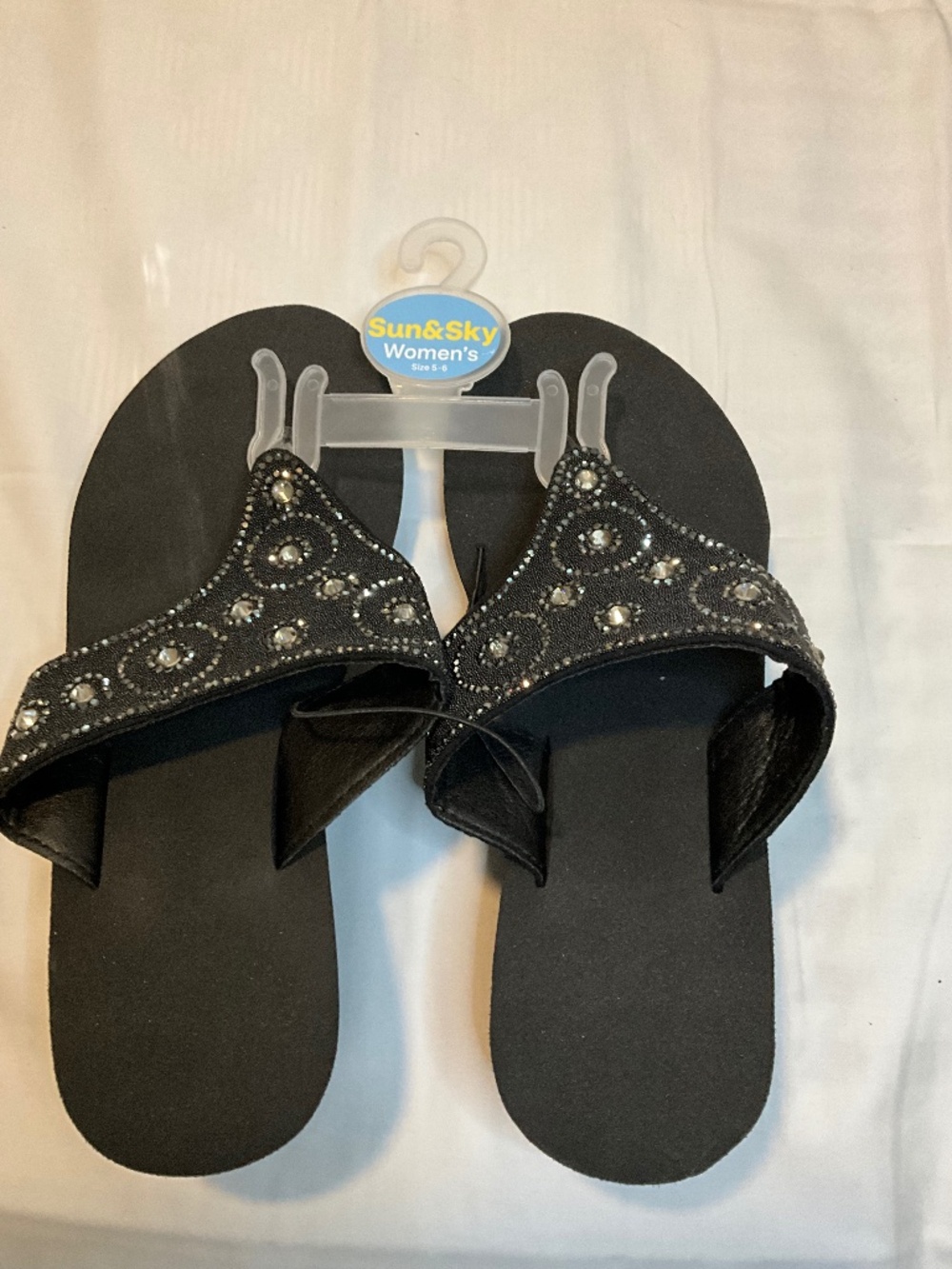 Sun & Sky black women's thong sandals featuring‎ rhinestone details.